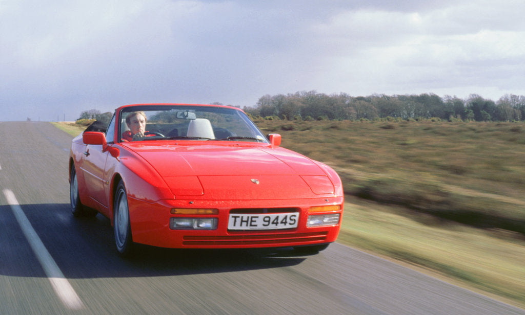 Detail of 1990 Porsche 944 cabriolet driving along by Unknown