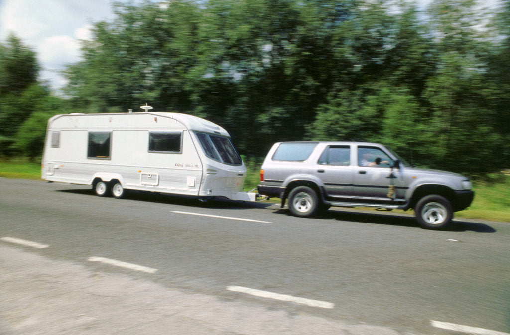 Detail of 1995 Toyota Landcruiser towing large caravan at speed by Unknown