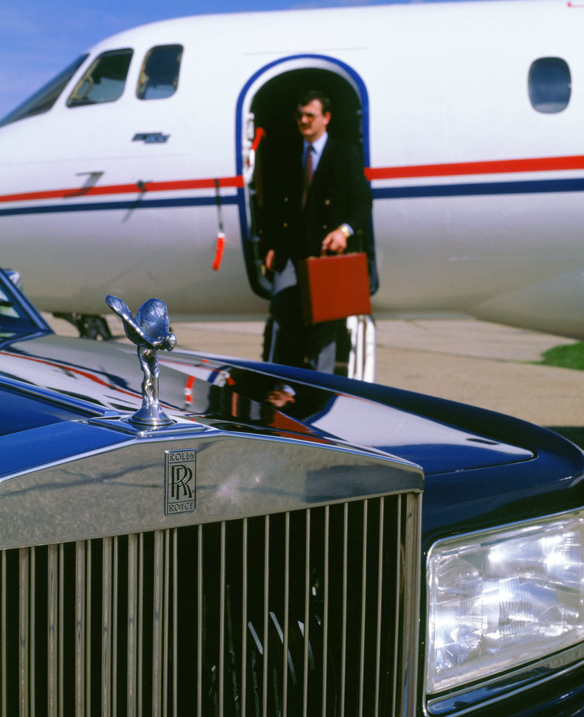 Detail of 1987 Rolls Royce Silver Spirit with executive disembarking jet by Unknown