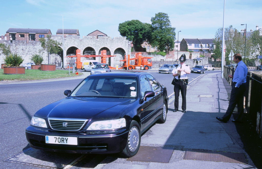 Detail of Policeman checking driver documents by Unknown