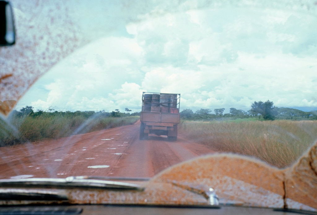 Detail of View through muddy windsreen on African dirt road by Unknown