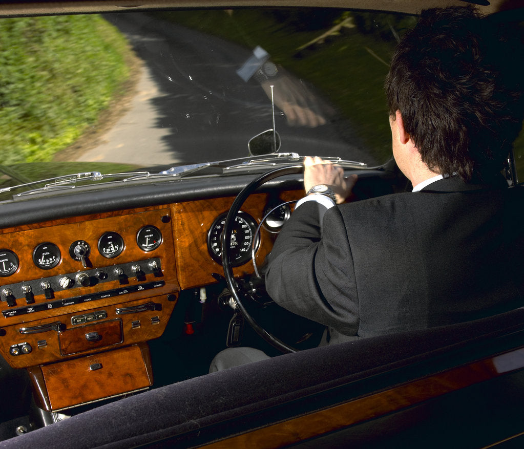 Detail of Chauffeur driving 1970 Daimler vanden plas DS 420 limousine by Unknown