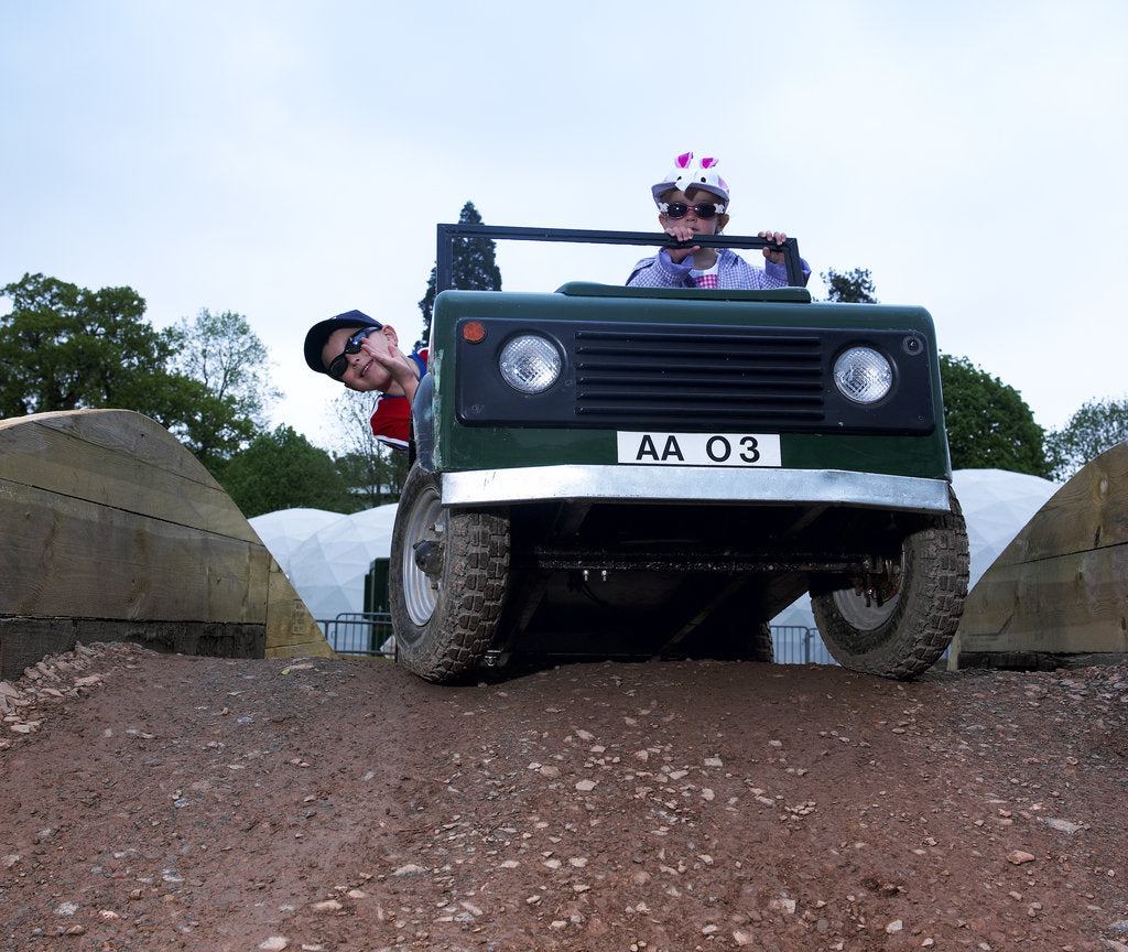 Detail of Child driving a toy Land Rover by Unknown