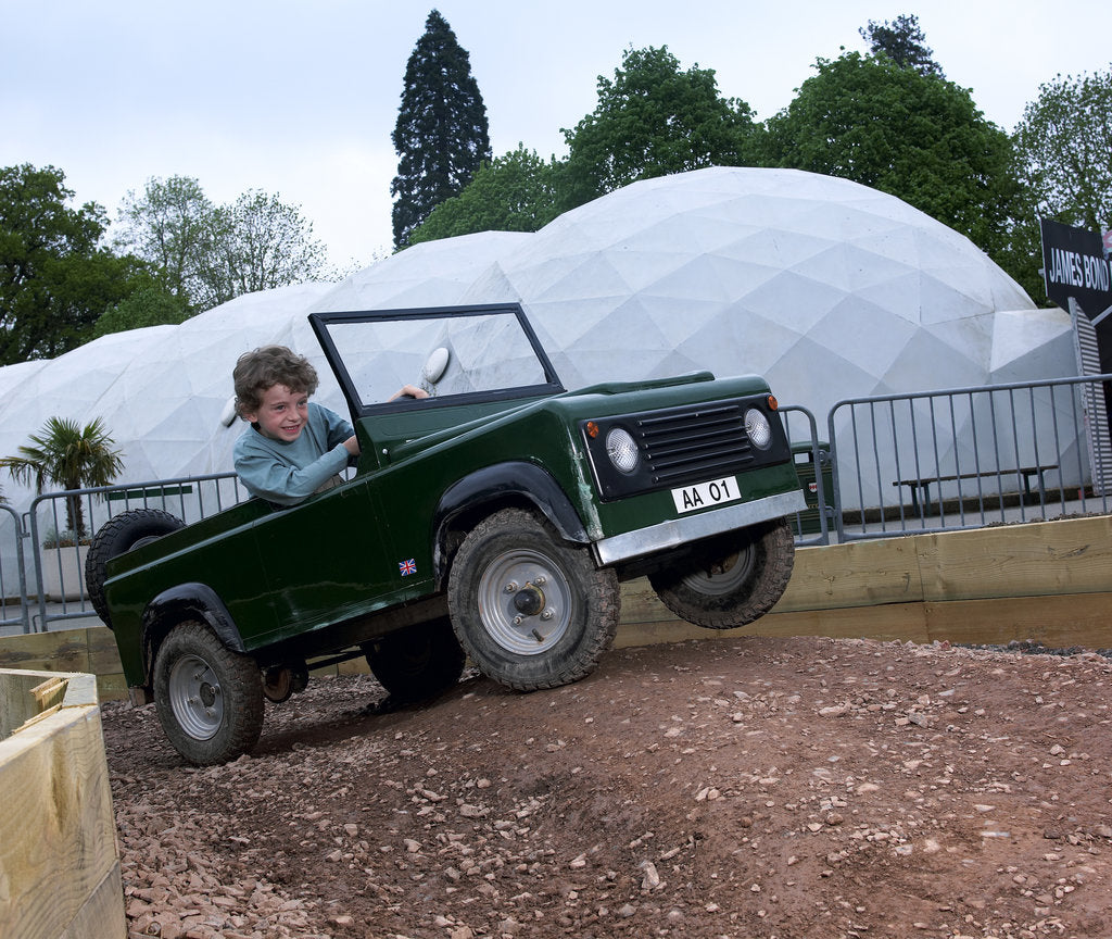 Detail of Child driving a toy Land Rover by Unknown