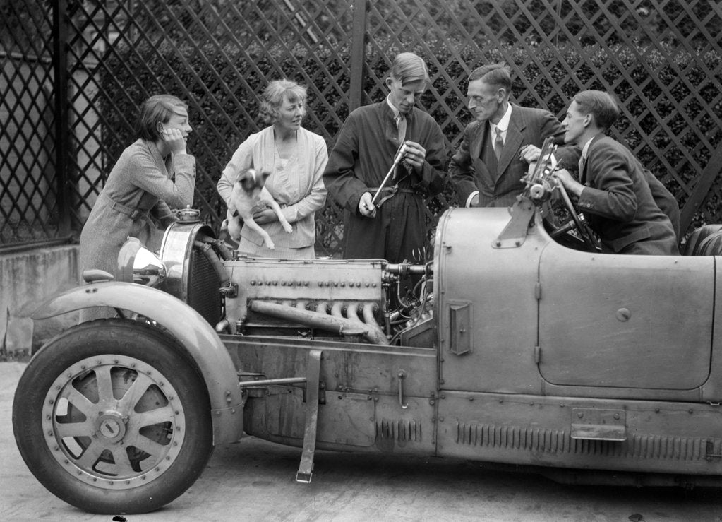 Detail of Denis Evans inspecting the plugs of his Bugatti Type 43 2262cc by Bill Brunell