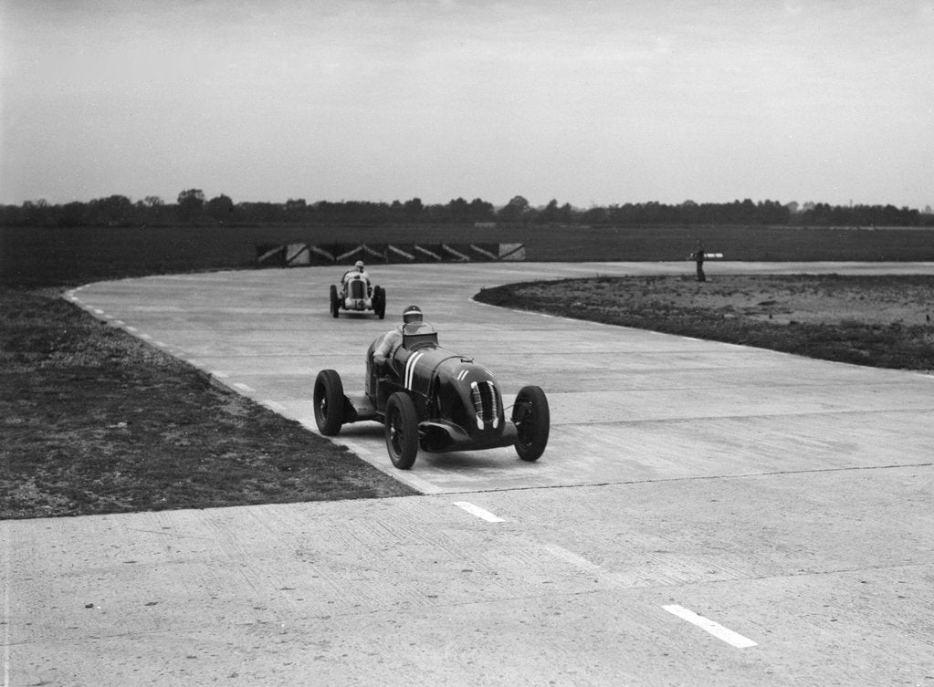 Detail of Rapier Special Racing single seater leading a MG in a race on the Campbell Circuit at Brooklands by Bill Brunell
