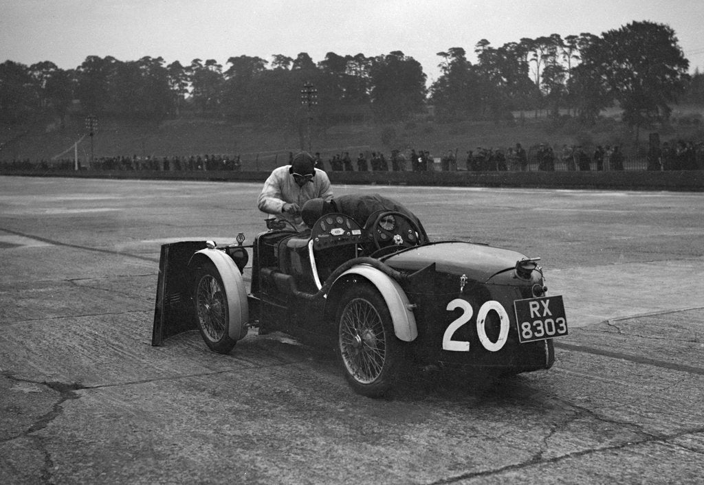 Detail of Mechanic making adjustments to a MG C type, Brooklands by Bill Brunell