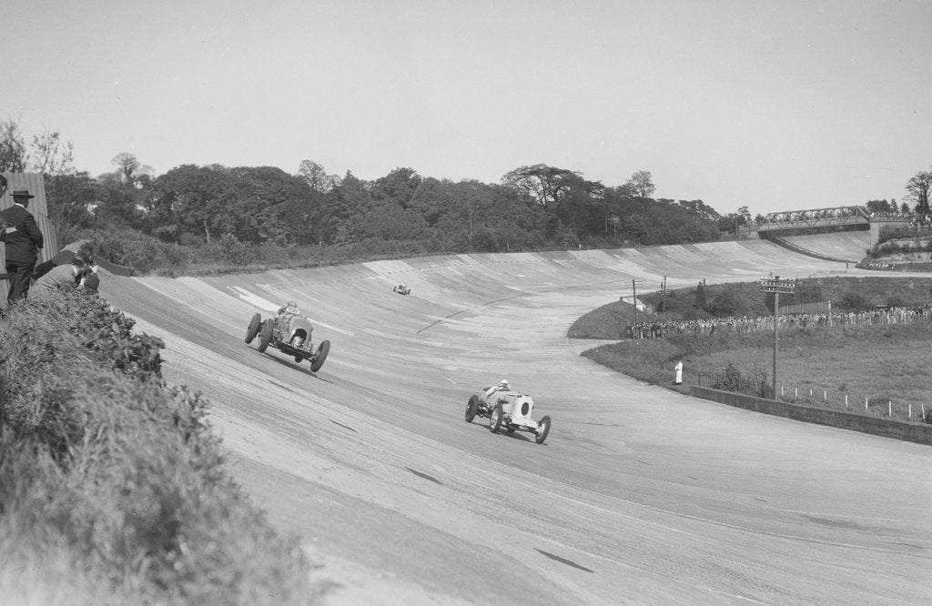 Detail of Sir Henry Birkin's Bentley racing RJ Munday's Vauxhall 30/98, BARC meeting, Brooklands, 16 May 1932 by Bill Brunell