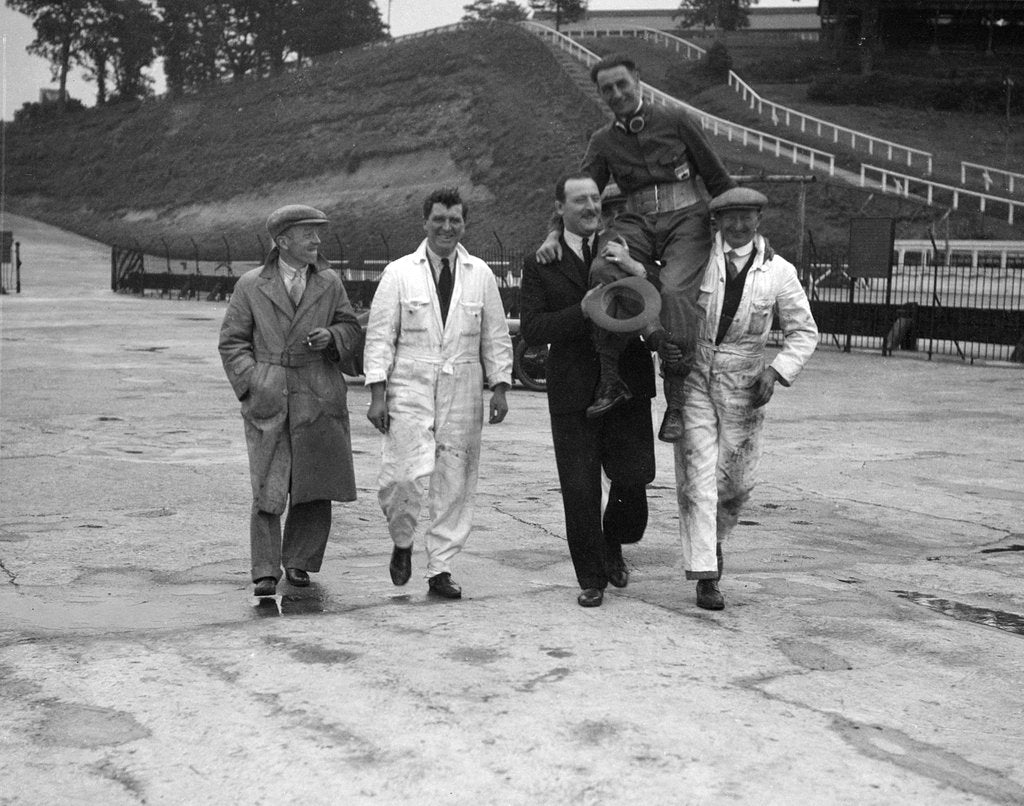 Detail of Leon Cushman being carried aloft after making a successful speed record attempt, Brooklands, 1931 by Bill Brunell
