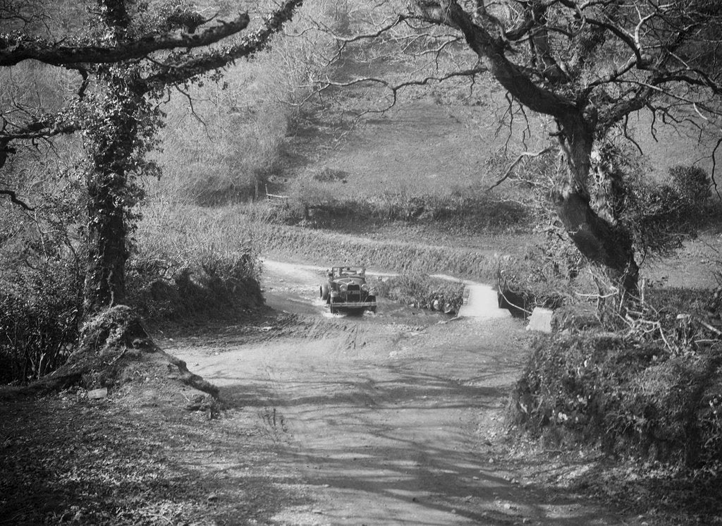 Detail of Kitty Brunell driving a 1930 Ford Model A 2-seater through a ford, 1931 by Bill Brunell