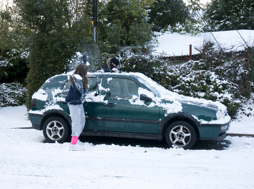 Detail of Girls palying with snowballs by VW Golf 2009 by Unknown