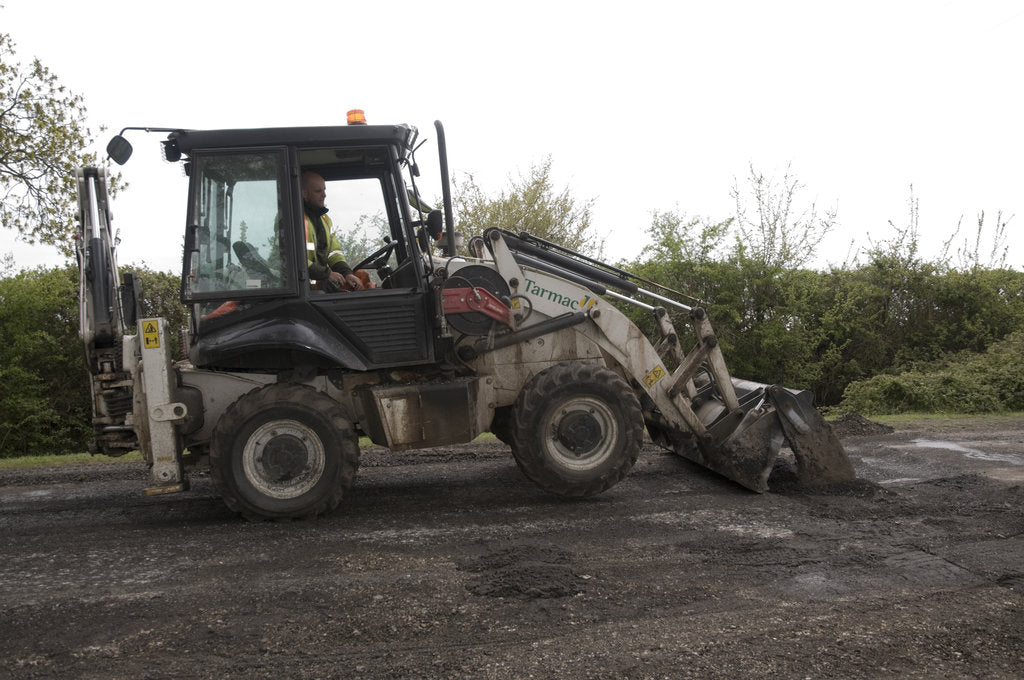 Detail of Road resurfacing work repairing potholes by Unknown