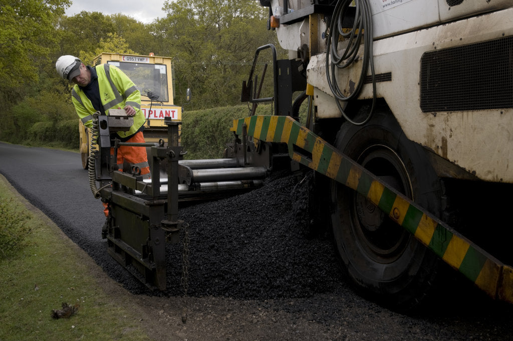 Detail of Road resurfacing work repairing potholes by Unknown
