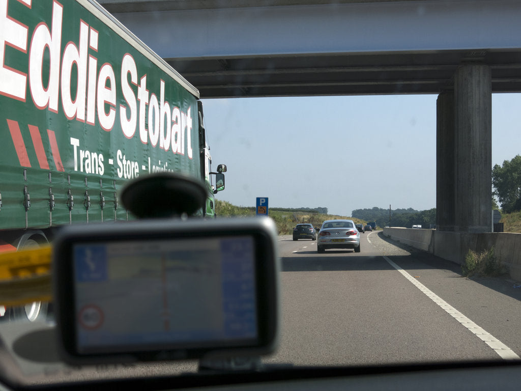Detail of Passing Eddie Stobart truck on the A46 with satnav screen on windscreen by Anonymous