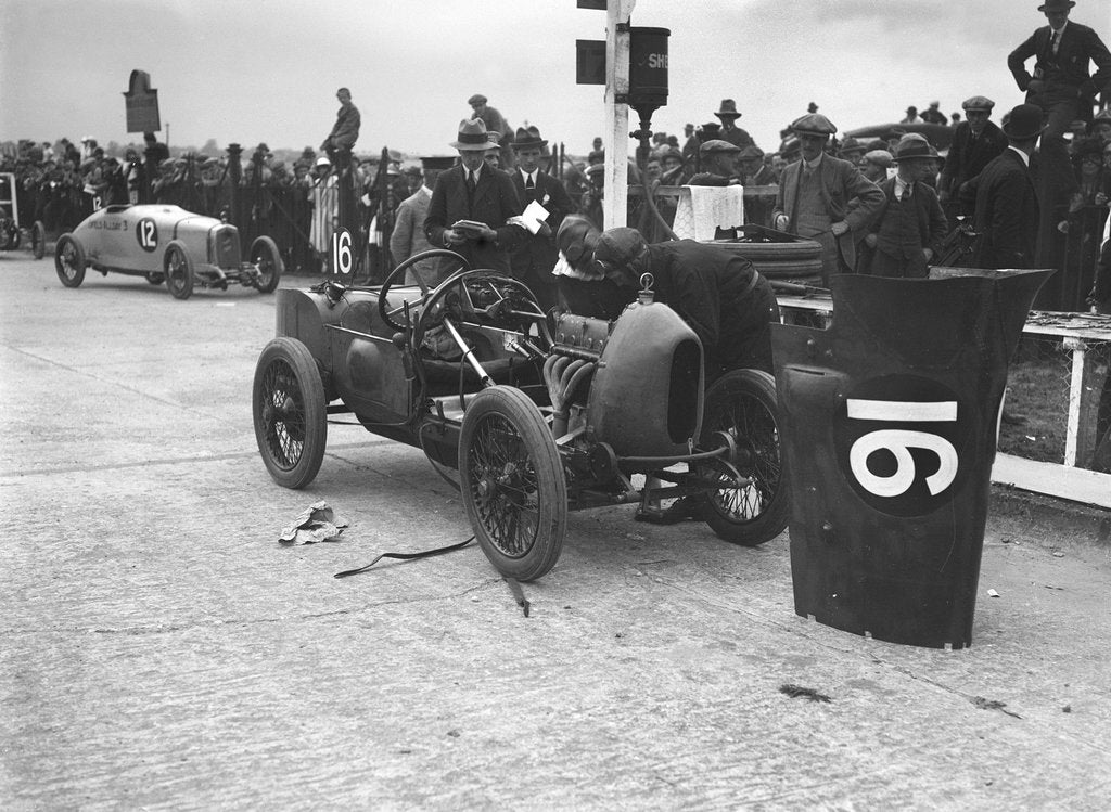 Detail of Leon Cushman working on his Bugatti Brescia at the JCC 200 Mile Race, Brooklands, Surrey, 1922 by Bill Brunell