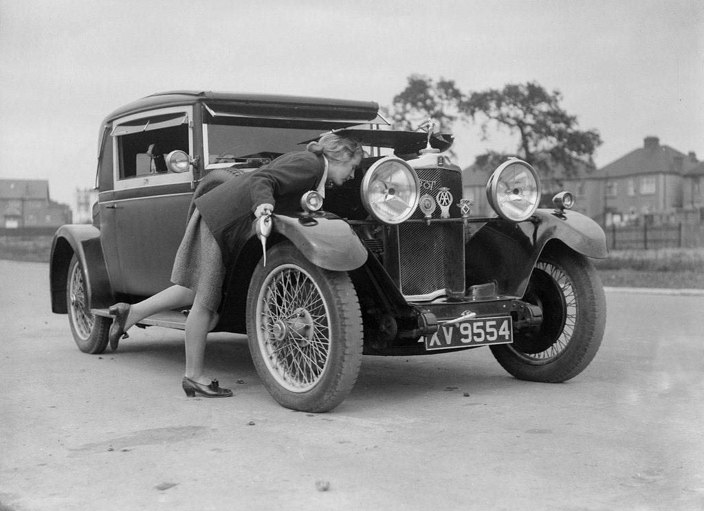 Detail of Kitty Brunell looking under the bonnet of a Talbot 14/45 sportsman's coupe, c1928 by Bill Brunell