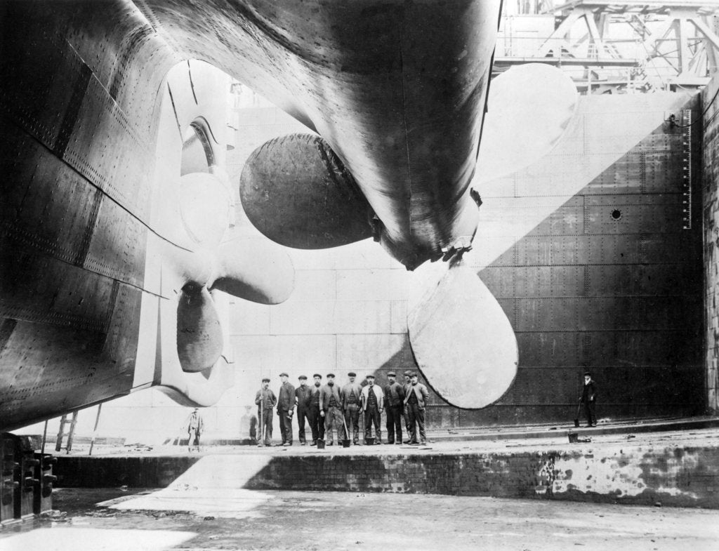 Detail of Workmen standing under one of the propellors of the Titanic, 31 May, 1911 by Anonymous