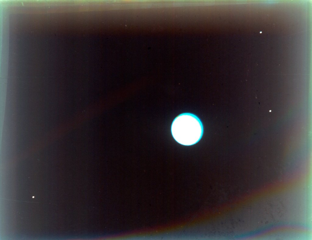Detail of Uranus with satellites Miranda, Ariel and Umbriel, from Voyager 2, 24 January 1986 by NASA