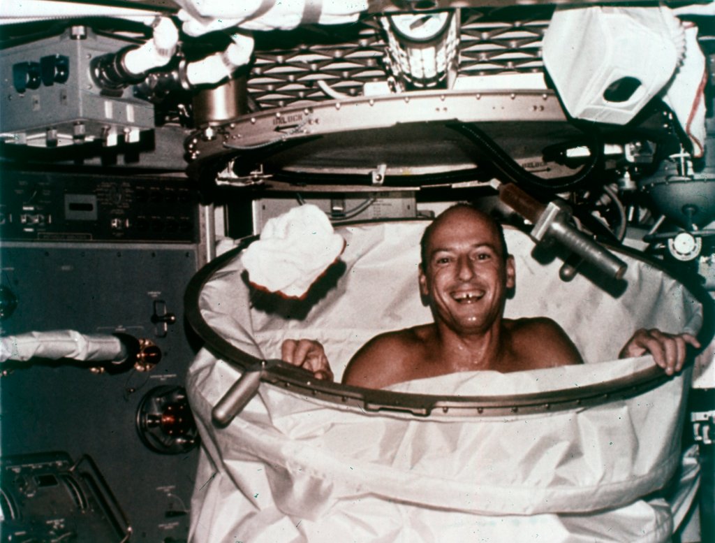 Detail of Conrad in shower facility aboard Skylab 2, 1973 by NASA
