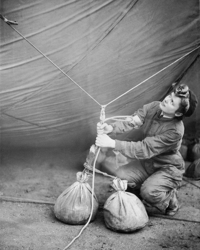 Detail of WAAF checking barrage balloon by Associated Newspapers
