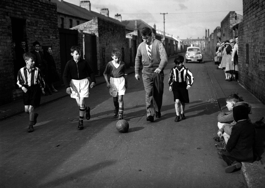 Detail of Footballer Bobby Charlton with children in his home town of Ashington by Associated Newspapers
