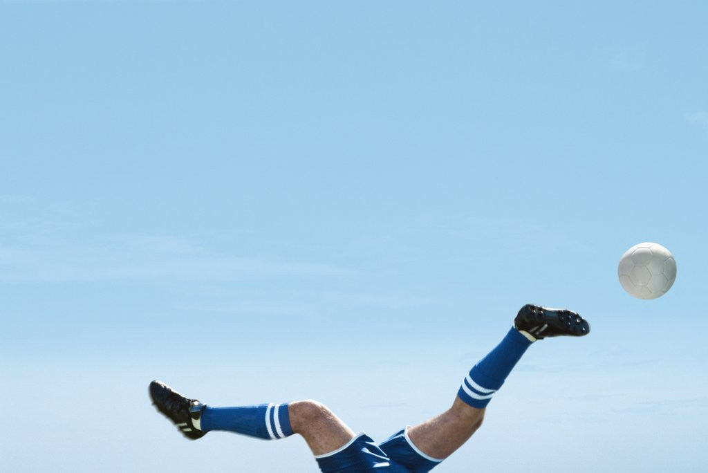 Detail of Soccer player upside-down attempting to kick the ball by Anonymous