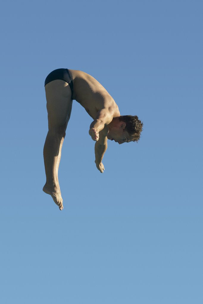 Detail of Profile shot of a young man diving by Corbis