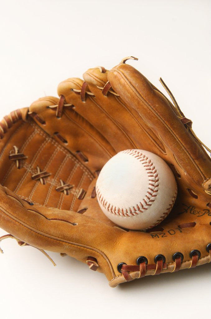 Detail of Baseball glove and ball by Corbis