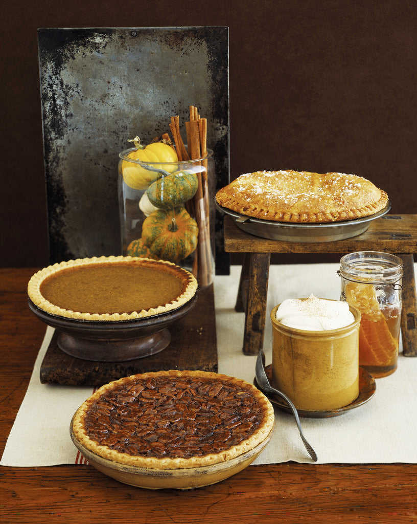Detail of Autumn Pies: Apple/Pear, Pumpkin, and Pecan with Honey and Whipped Cream by Corbis