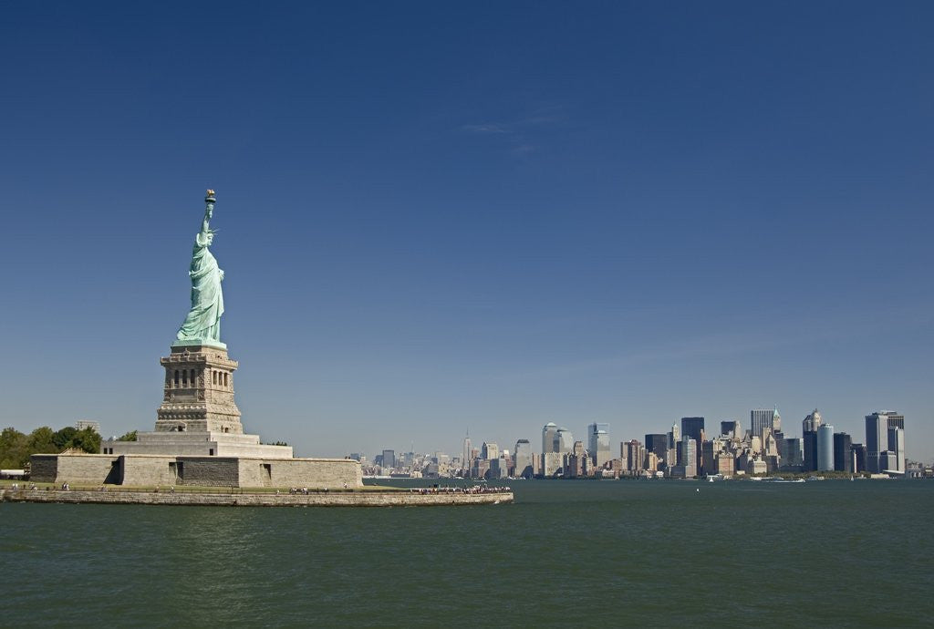 Detail of Statue of Liberty, Liberty Island and New York Skyline by Corbis