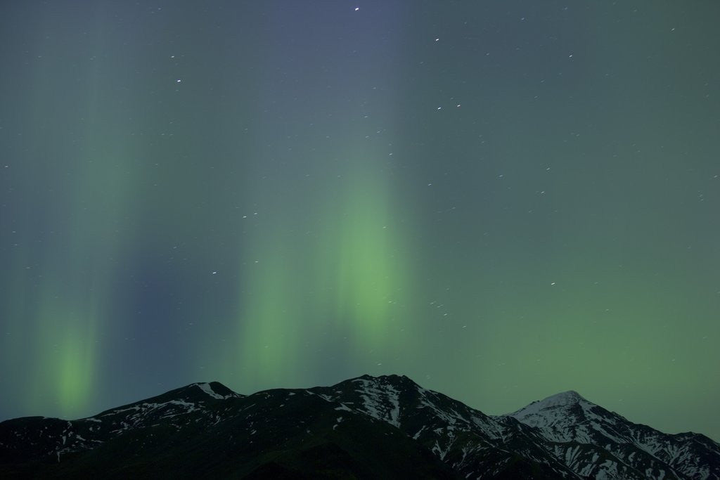 Detail of Aurora Borealis over Mountain Range by Corbis