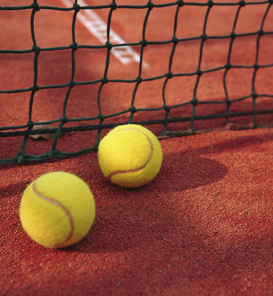 Detail of Tennis balls and net by Corbis