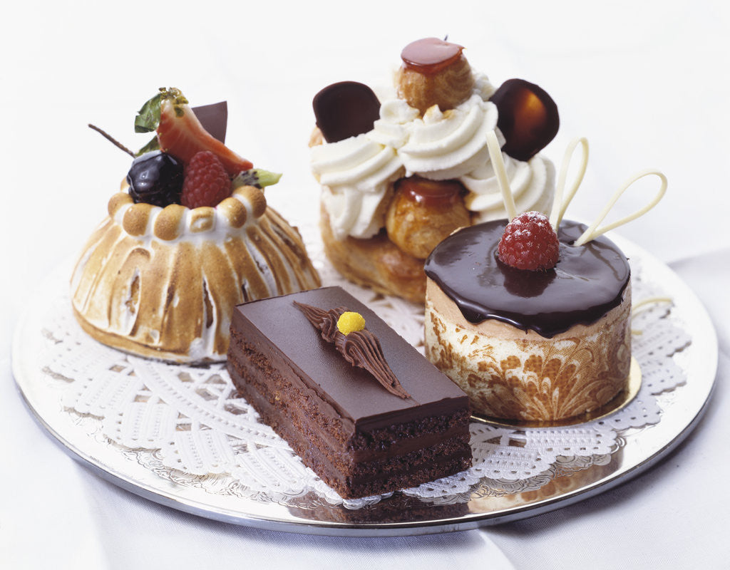 French Pastries on Silver Plate with Doily by Corbis