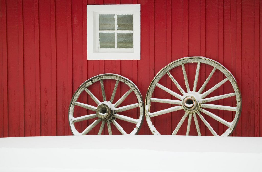 Detail of Wagon Wheels on Snow Against Stable by Anonymous