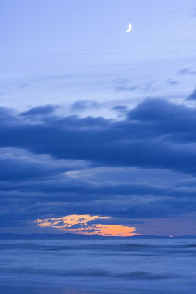 Detail of New Moon and Cumulus Clouds Above Sea at Winter Dawn by Corbis