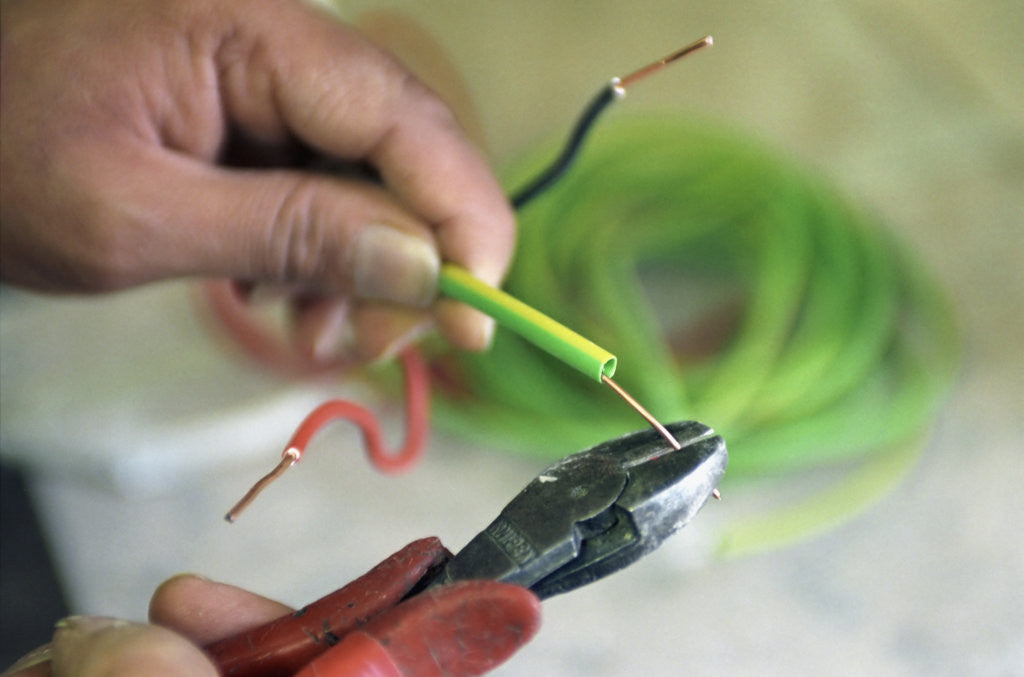 Detail of Electrician Stripping Electrical Wire by Anonymous