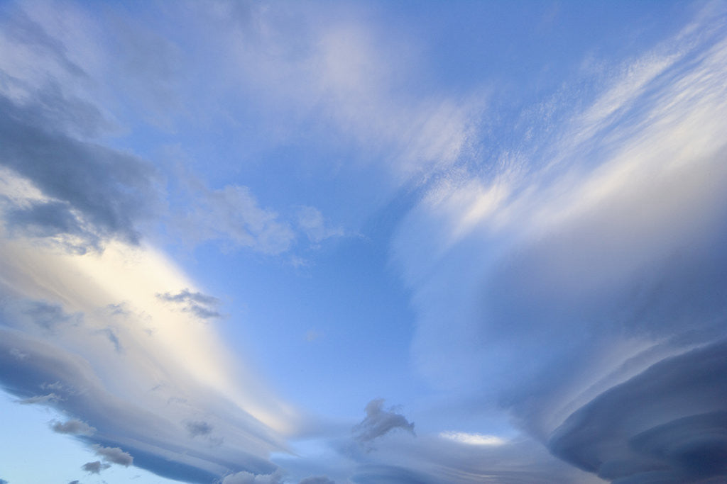 Detail of Bright Cumulus and Lenticular Clouds at Sunrise by Anonymous