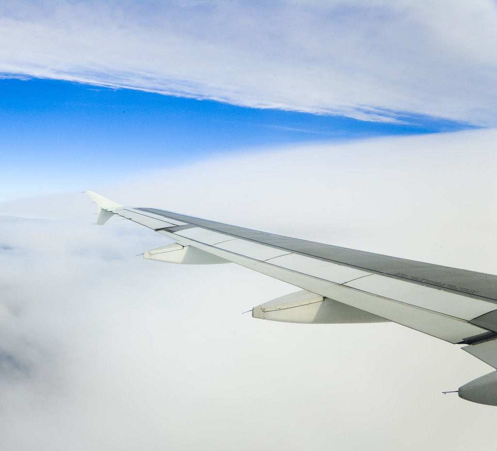 Detail of Airplane Wing Above Clouds by Anonymous