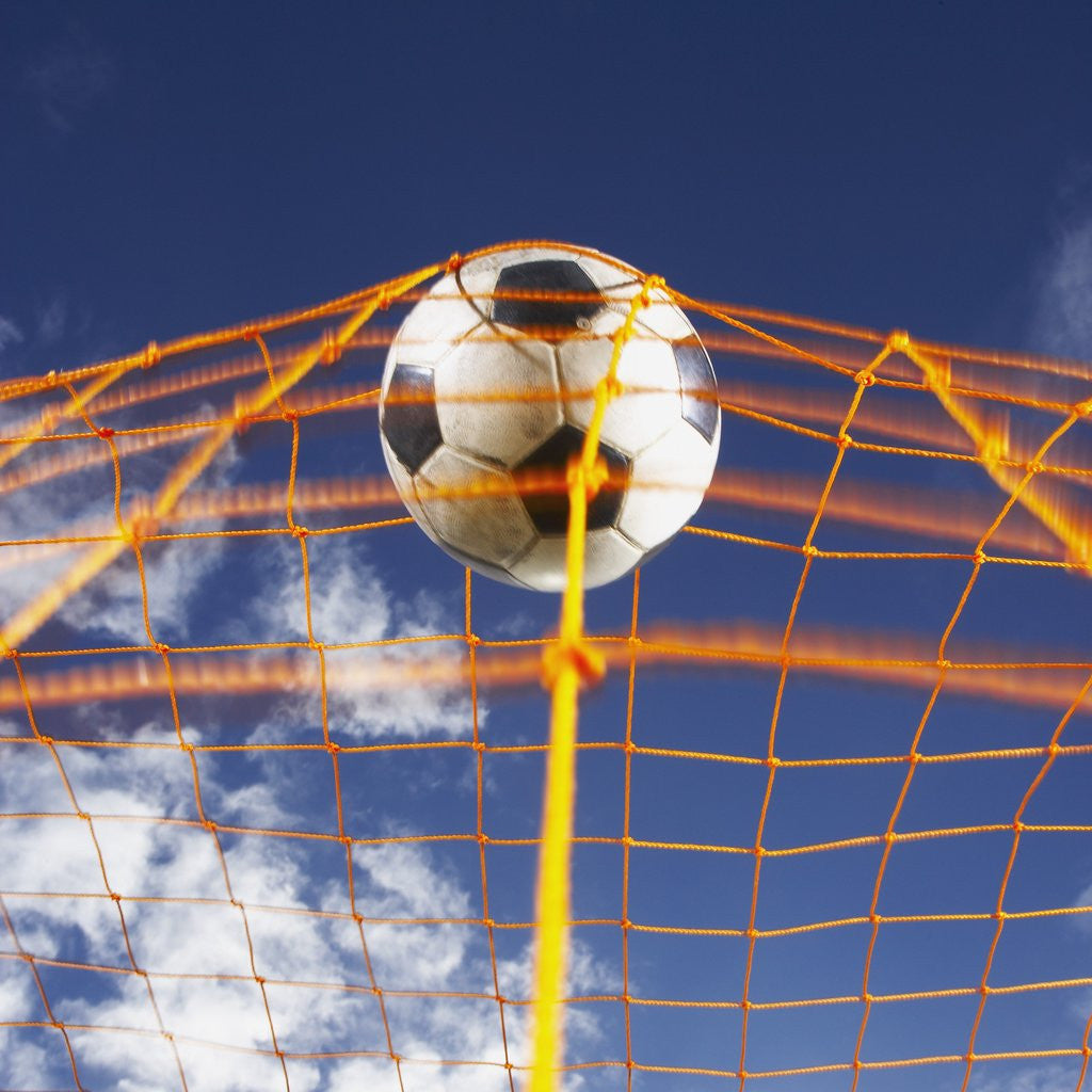Detail of Soccer Ball Going Into Goal Net by Corbis