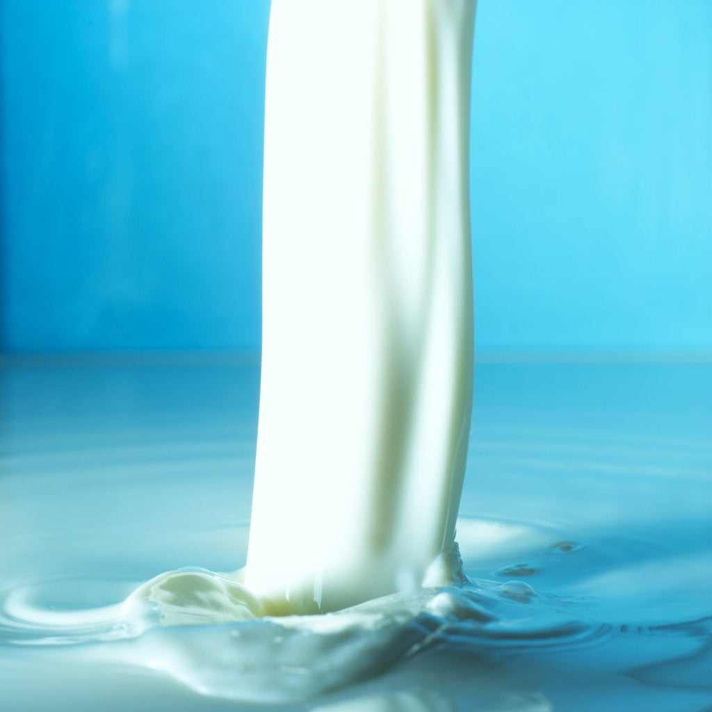 Detail of White liquid pouring by Corbis