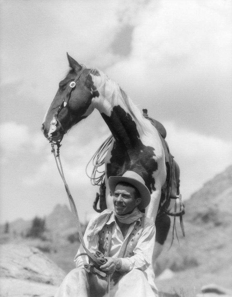 Detail of 1930s Cowboy Sitting In Front Of Horse Holding Reins Spotted Paint Pinto by Anonymous