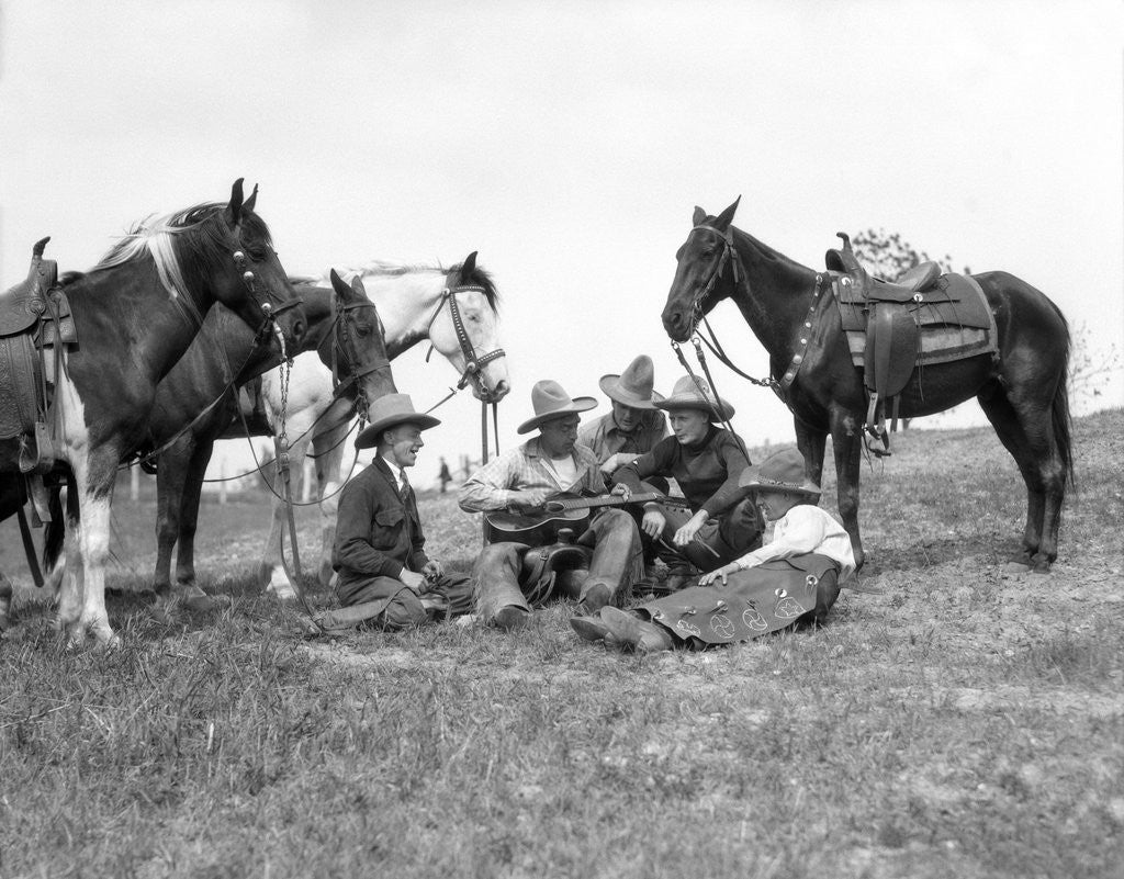 Detail of 1920s 1930s Five Cowboys Sitting By Their Horses One Holds Guitar Singing by Anonymous