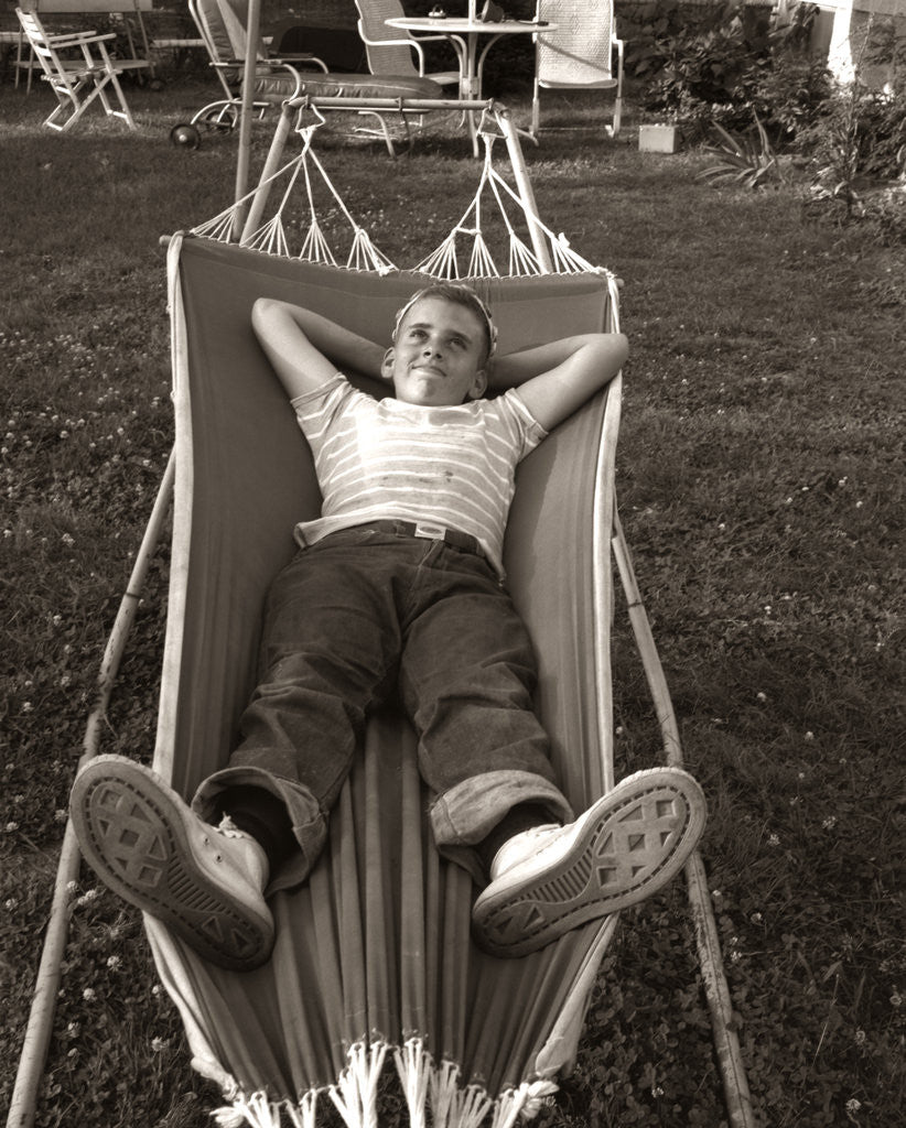 Detail of 1950s Relaxed Boy Lying In Suburban Backyard Hammock by Anonymous