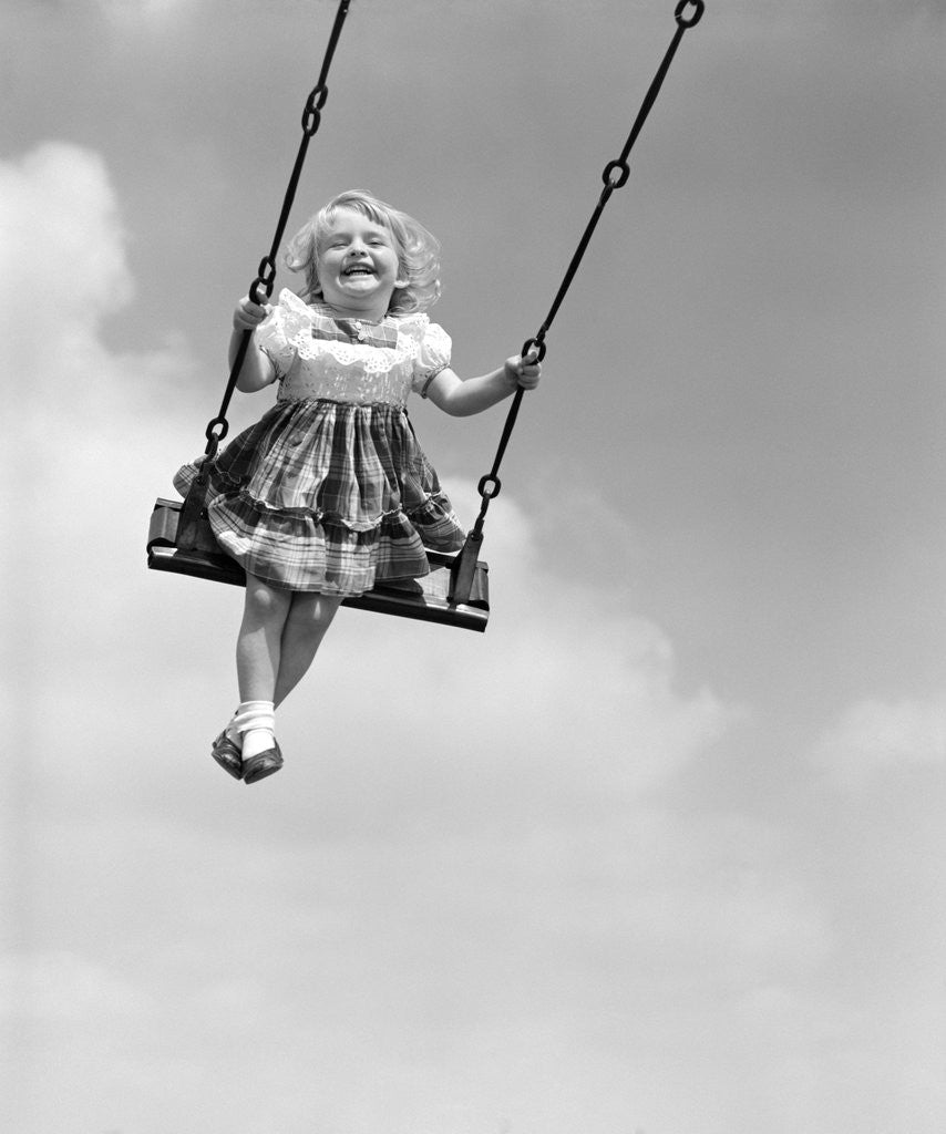 Detail of 1950s Laughing Little Girl Swinging High On Outdoor Swing by Corbis
