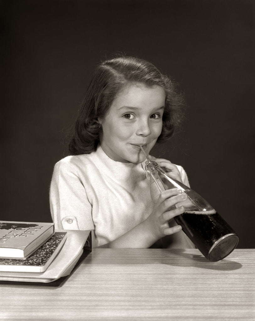 Detail of 1950s 1960s School Girl Using Straw Drinking Carbonated Beverage From Bottle by Corbis