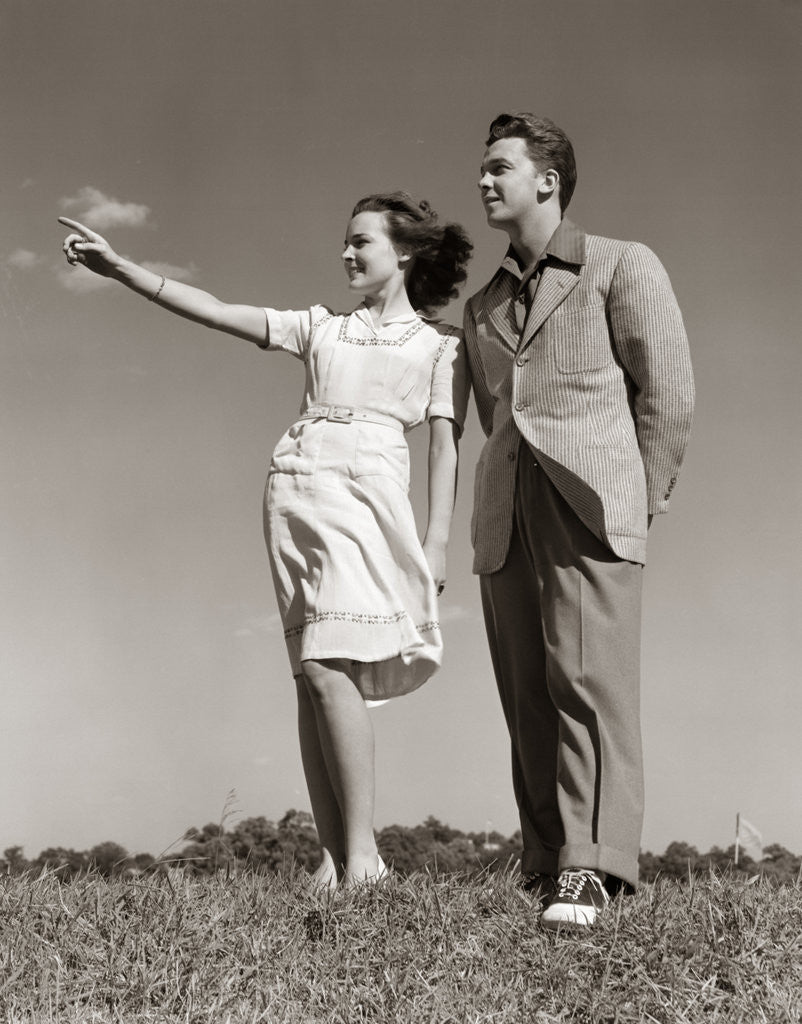 Detail of 1940s Teenage Couple Standing Together Outdoors Girl Pointing by Anonymous