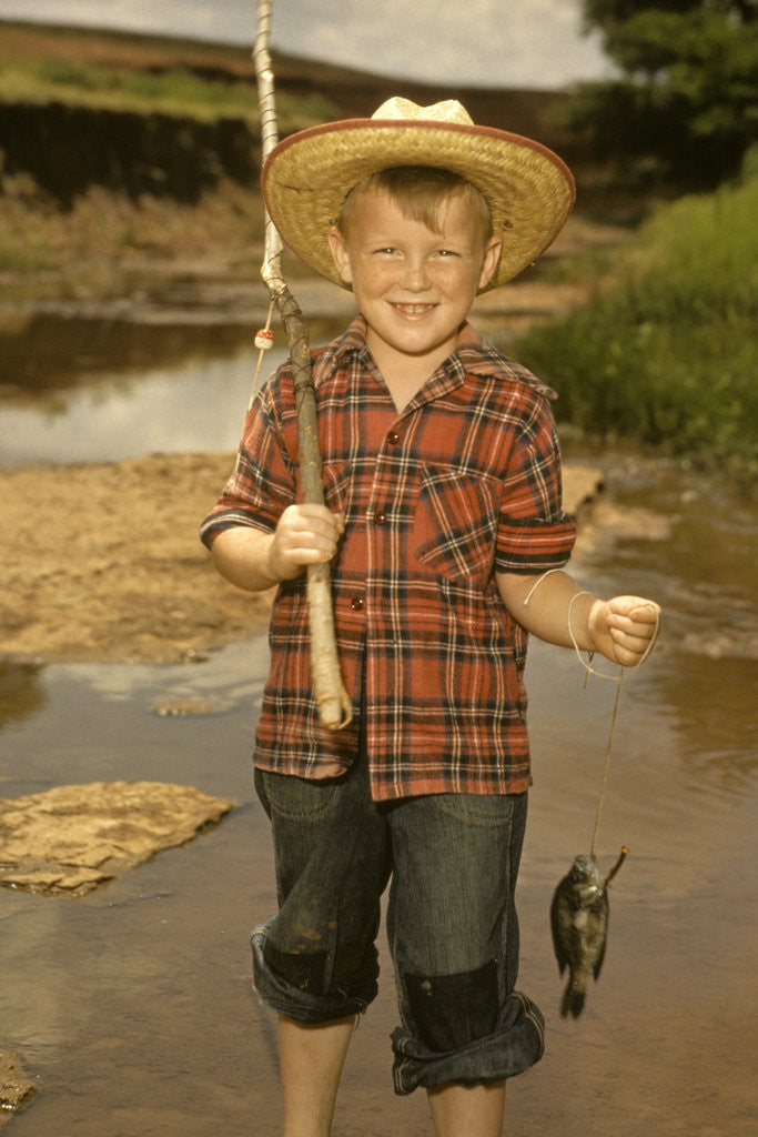 Detail of 1950s Boy Straw Hat Holding Fishing Pole Wearing Plaid Shirt Blue Jeans by Anonymous