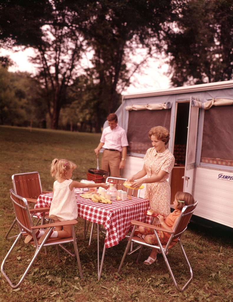 Detail of 1960s Family Rv Camping Father Grilling Mother And Girls Setting Table by Anonymous