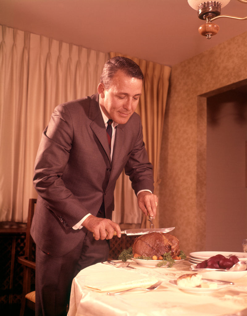 Detail of 1960s Well-Dressed Man Carving Roast Beef At Dinner Table by Corbis