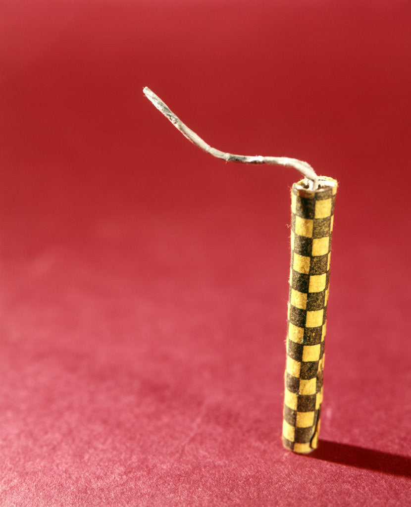 Detail of 1970s Single Yellow Firecracker Fuse Red Background by Corbis
